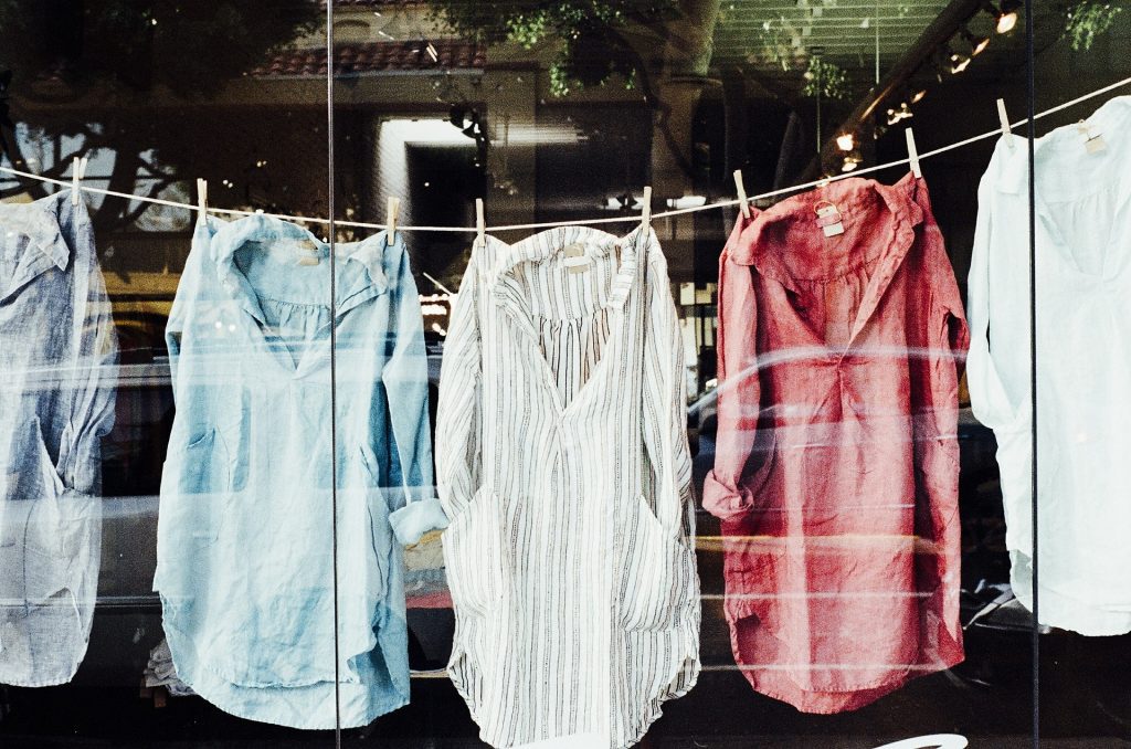 Linen shirts hanging on a clothesline in a store window display